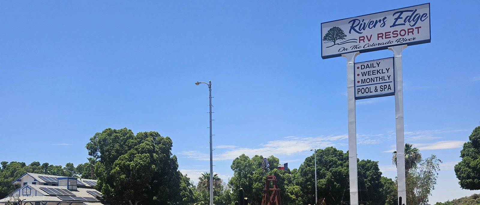Rivers Edge RV Resort sign — daily, weekly, monthly, pool & spa — with the office beyond, Winterhaven